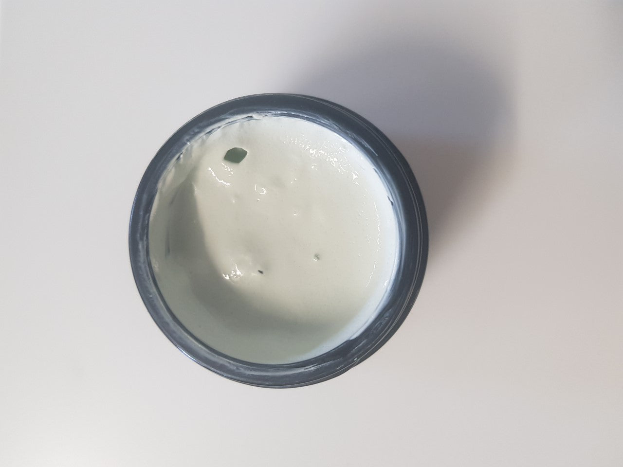 Aloe Vera Cosmetics Australia firming clay mask with aloe vera for skin care, shown in a jar with a smooth clay texture.
